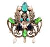 <span class='ref_item'>6 -</span> <span class="object_title">BROCHE DE METAL DORADO, PIEDRAS Y PERLAS DE IMITACIÓN</span>  <p><span class="technical_description">Broche de inspiración modernista realizado en metal dorado. En su centro la figura de una efigie alada rodeada por turquesinas, piedras de imitación verdes y azules, y perlas de imitación de color golden. Colgando en su parte inferior dos perlas imitación con forma barrilete.<br/>Cierre. Aguja<br/>Medidas:5,3 x 5cm</span><br>Peso: <span class="PESO_HCES1">20,20</span> <span class="PESOUMED_HCES1">gr.</span><br></p>