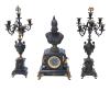 <span class='ref_item'>205 -</span> <span class="object_title">GUARNICIÓN RELOJ Y CANDELABROS, BARCELONA S. XIX.</span>   <p><span class="technical_description">Reloj decorado con el busto de la diosa Atenea en calamina con base cuadrada. Desperfecto en una esquina y está un poco suelta. <br/>Cuerpo del reloj decorado con aplicaciones en bronce dorado de motivos egipcios. Esfera con tapa de cristal, de números romanos y sello de marca Brazalete Modern Barcelona. Con llaves para dar cuerda. Necesita revisión. Se acompaña por una pareja de candelabros en base cuadrada y cuerpo en forma de copa. Decorados con aplicaciones en metal dorado, algunas sueltas y con faltas. A uno de ellos le faltan dos brazos. <br/>Medidas reloj: 64x32x18cm<br/>Medidas candelabros: 70x13x12cm</span><br></p>